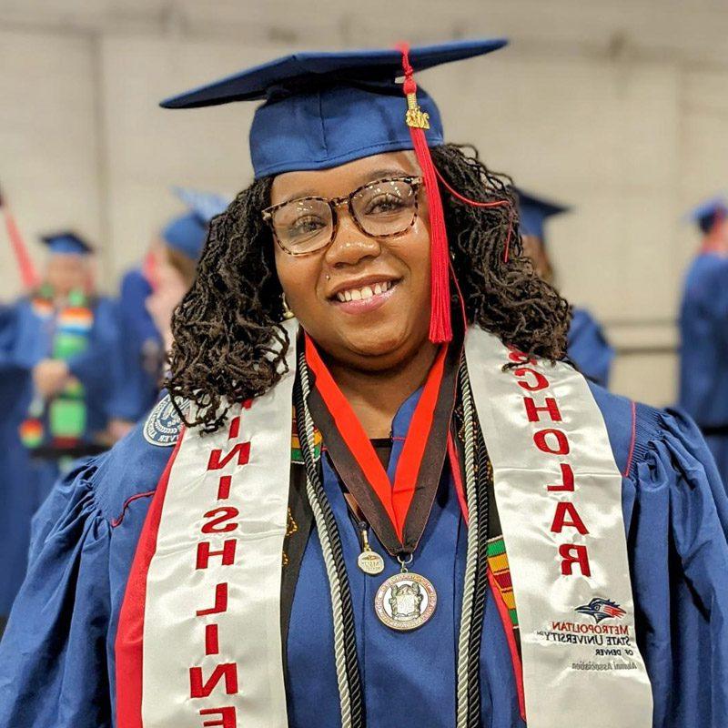 Alysha Harlan at graduation in her gown and cap